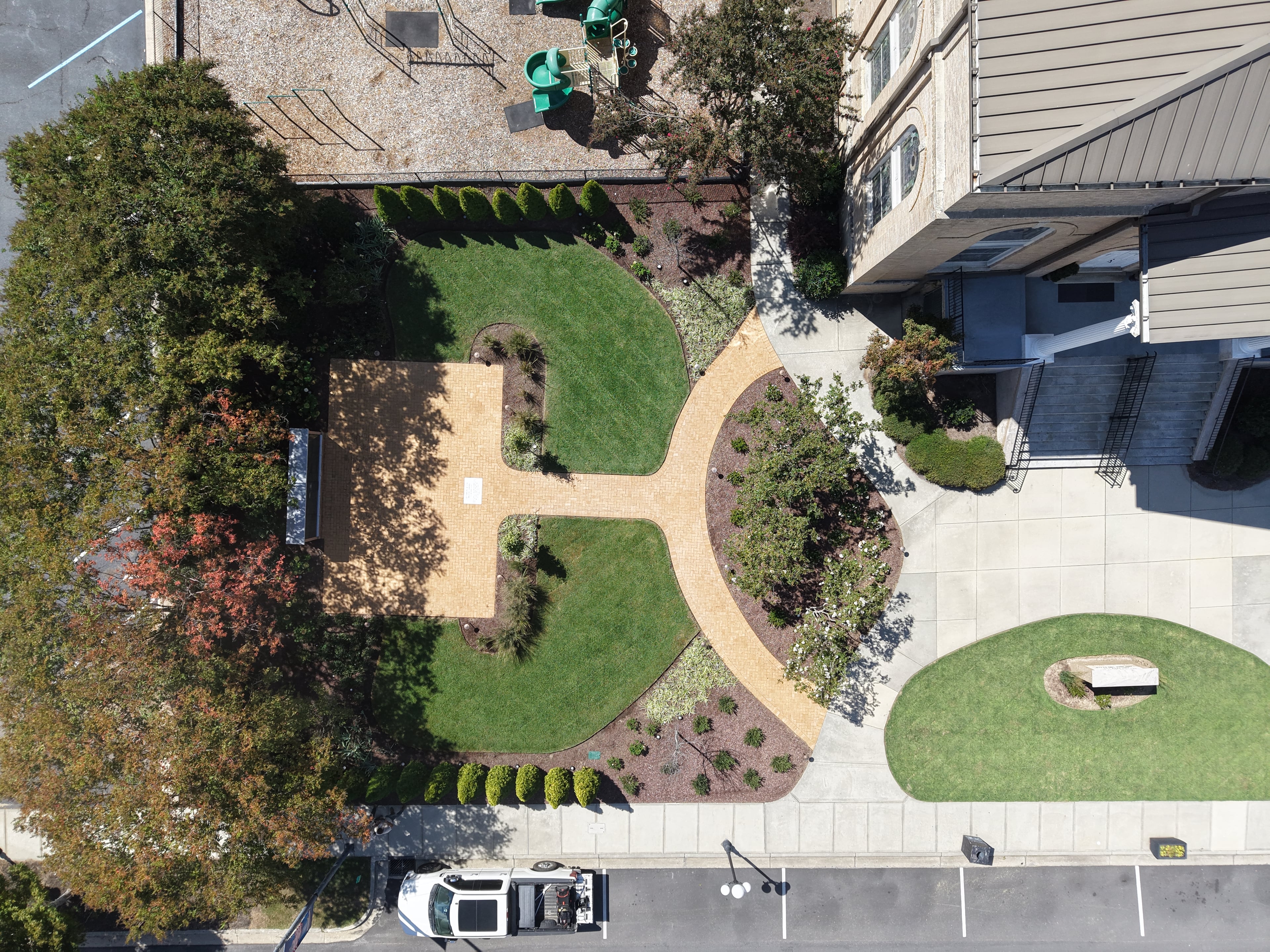 Overhead view of maintained church grounds with curved walks and lawn panels