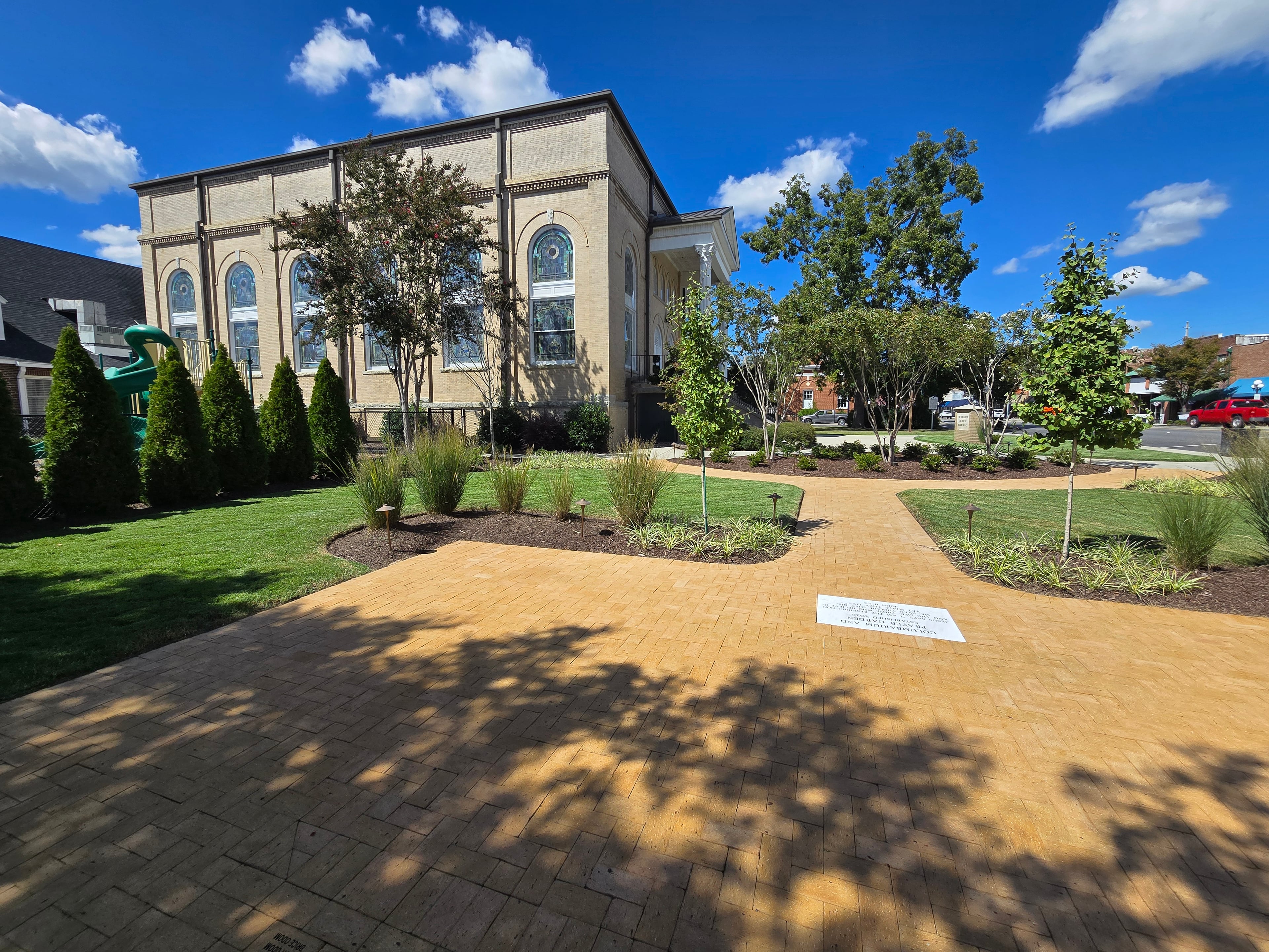 The front lawn and curved walk in front of a stone church