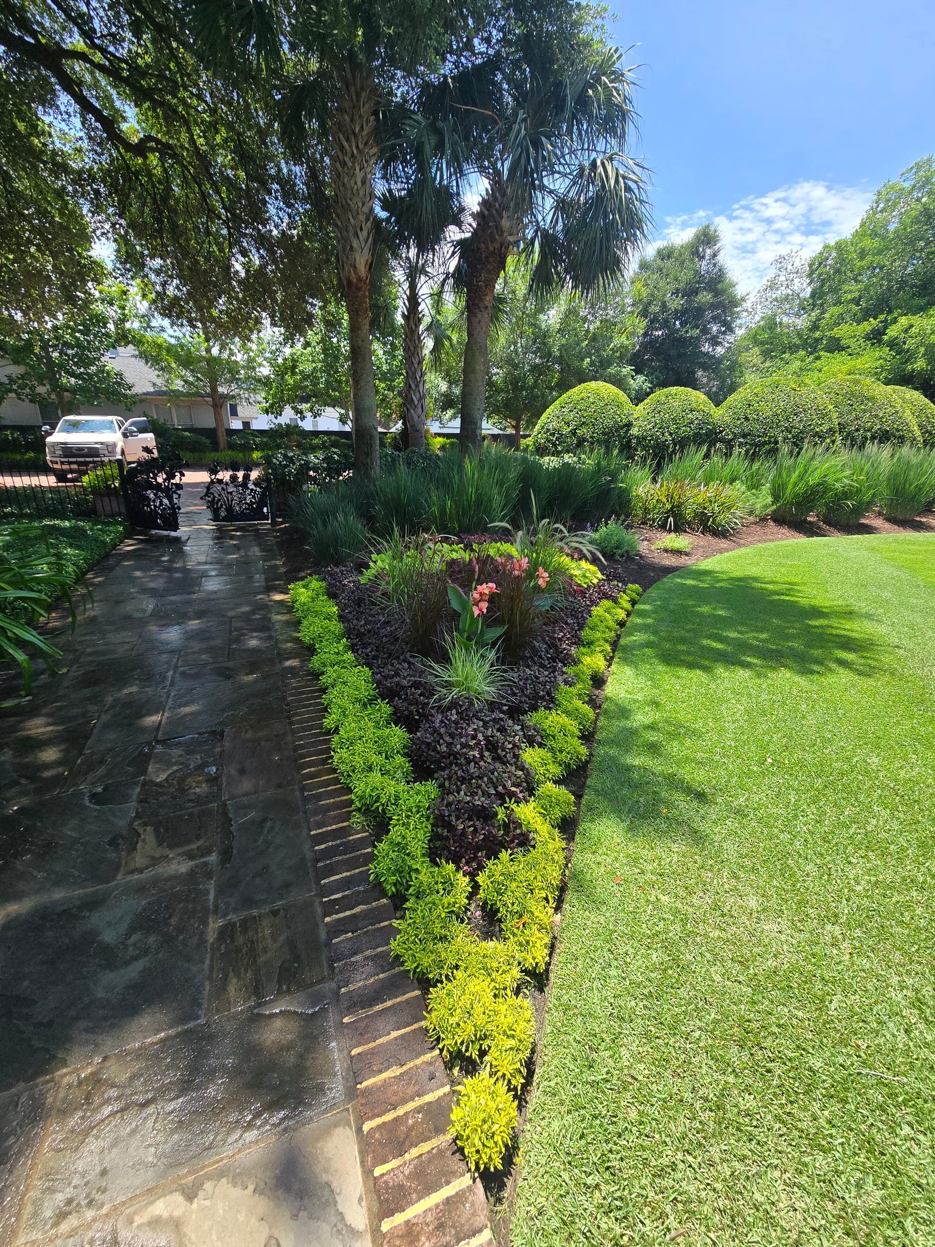 Shaped hedges and a color bed kept in scale with the walk and lawn